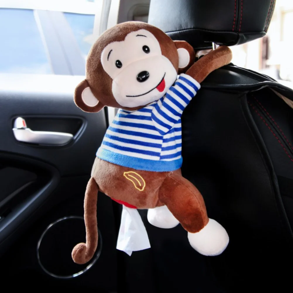 Plush monkey tissue dispenser with tissues humorously pulled from the back, wearing a blue striped shirt and smiling.